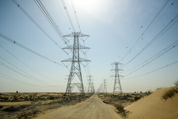 Rows of Electricity power lines along a road in a desert landscape, Dubai, USA