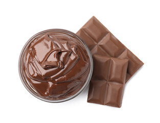 Bowl with melted chocolate and pieces isolated on white, top view