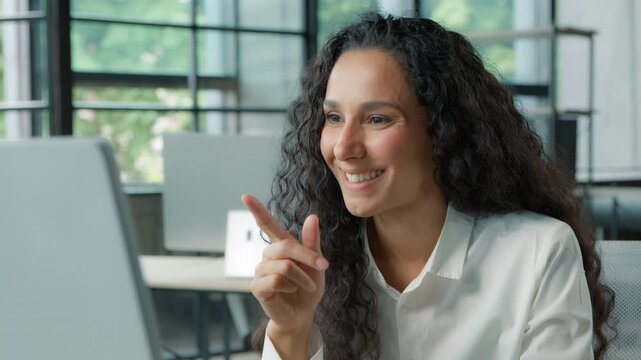 Pensive thinking Hispanic business woman talking video call with computer in modern office businesswoman happy female girl come up with idea talk chat conference manager smiling working communicate