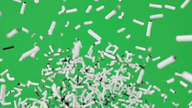 Scattered white broken pieces on bright green background abstract texture