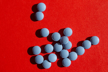 Blue pills on red background