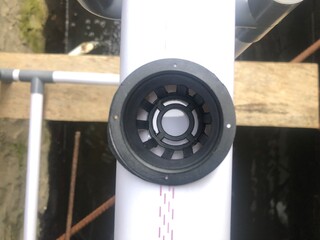 Close-up of hydroponic pipes and net cups ready for planting