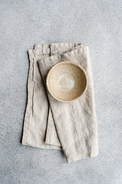 Overhead view of a ceramic bowl on a folded napkin on a table