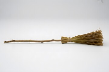 Rustic broom made of twigs and feathers