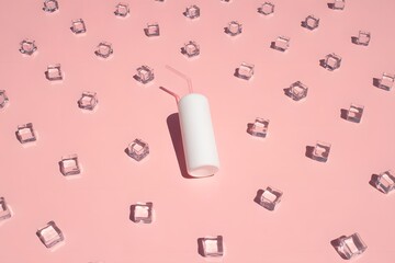 Single tampon surrounded by ice cubes on pink background