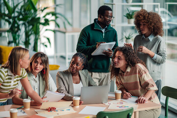 Diverse team collaborating in modern office meeting