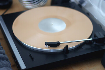 Playing vinyl record on the gramophone at home. Selective focus.
