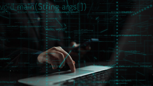 A focused software engineer types on a laptop with program code glowing on the screen, representing a cutting-edge digital environment and innovative technology. Xenic