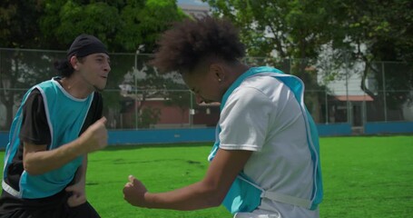 Male soccer players celebrate emotional victory on urban field, shouting and embracing in joyful triumph after scoring goal, expressing friendship, energy, and passion for the sport - Powered by Adobe