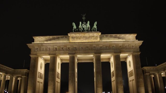 Nighttime Lights, City Icon, Gate Beauty. Historic Brandenburg Gate becomes beacon of light in twilight hours.