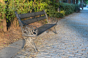 Ornate iron bench in Seville’s park illuminated by soft afternoon light, evoking calm, elegance, and the timeless beauty of Andalusian craftsmanship and urban serenity