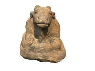 Ancient stone sculpture of Nandi, Lord Shiva's sacred bull mount, seated in devotion. A timeless Hindu temple artifact symbolizing purity and patience.