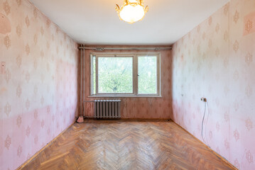 Living room in bad condition in an abandoned building. Abandoned house interior.