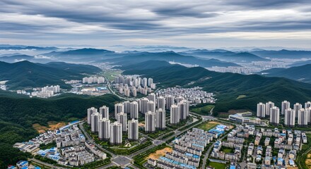 Apartment complex in green hillsides under a cloudy sky cityscape