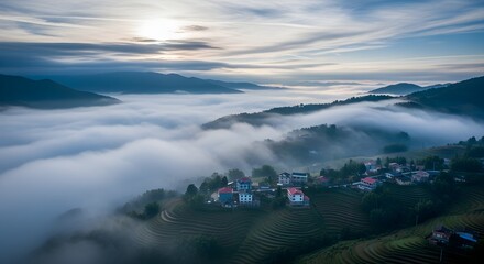 Mountain landscape with fog over lake at sunrise