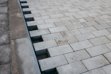 Laying paving stones in the courtyard of a new house