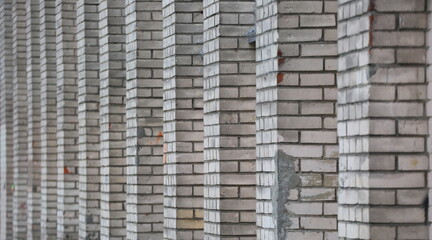 A white brick wall with repeating protrusions