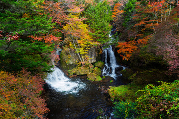 Ryuzu Waterfall or Ryuzu Cascades with autumn background is one of Landmark in Nikko to see autumn colors Nikko, Tochigi, Japan