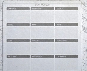 Year Planner template for 12 months on textured paper, set against a grunge border. Represents time management, goals, scheduling, business planning, agenda, and vintage background concept.