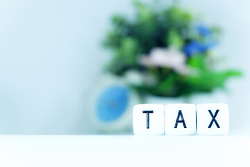 Tax Season: TAX Spelled with Dice horizontally placed on the right of the picture a White Surface digitally generated image stock photo copy space