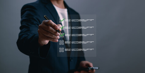 Businessman using digital pen to check off items on virtual checklist interface. Concept of task management, planning, productivity and digital workflow in business
