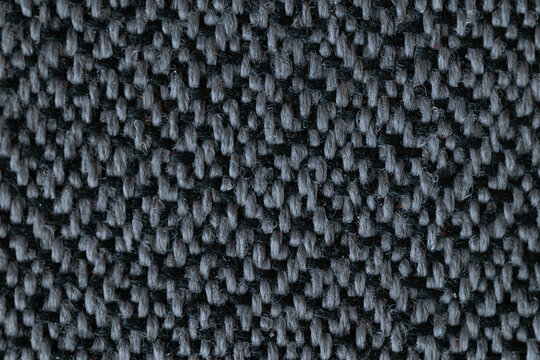 A macro close-up showcasing the rich, intricate textures of textile, tapestry, and leather materials