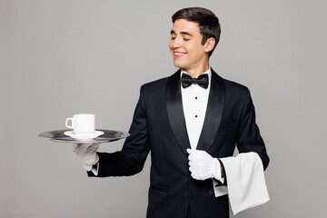 Young barista male waiter butler man wears shirt black suit bow tie elegant uniform work at cafe...
