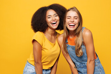 Two young cheerful joyful friends buddies women wear denim casual clothes look camera laughing...