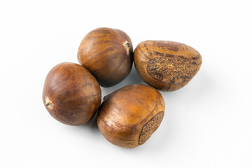 Close-up of fresh brown chestnuts isolated on white background, showing natural texture and detail. Ideal for healthy food, nut ingredient, autumn harvest, and organic nutrition concepts.