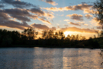Beautiful sunset over a lake at Rushcliffe Country Park in Nottinghamshire, UK.