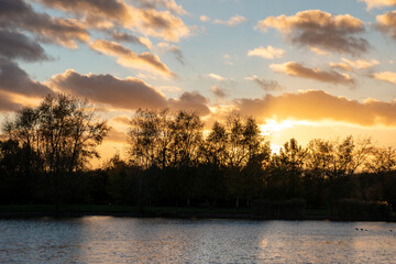 Beautiful sunset over a lake at Rushcliffe Country Park in Nottinghamshire, UK.