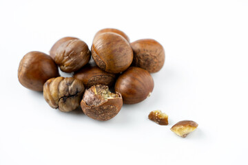 Close-up of fresh brown chestnuts isolated on white background, showing natural texture and detail. Ideal for healthy food, nut ingredient, autumn harvest, and organic nutrition concepts.