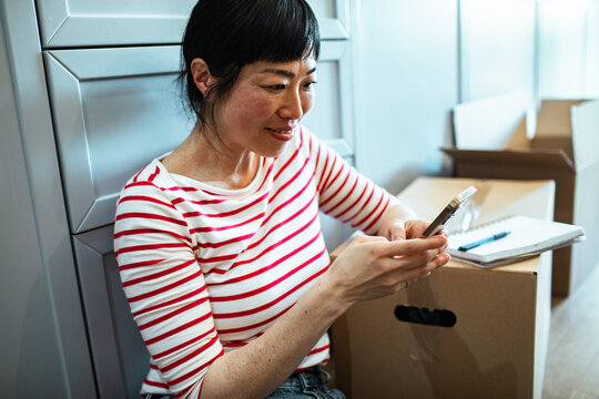 Young woman using smartphone while moving