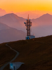 Alpine sunset or sundowner with a communications tower at Mount Diedamskopf, Schoppernau, Bregenz, Vorarlberg, Austria