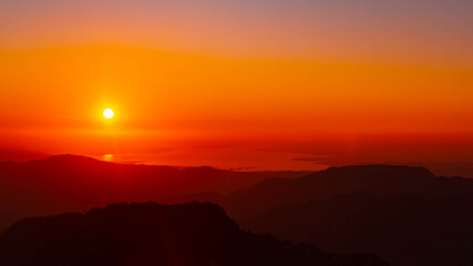 Alpine sunset or sundowner with reflections in lake Bodensee seen from Mount Diedamskopf, Schoppernau, Bregenz, Vorarlberg, Austria