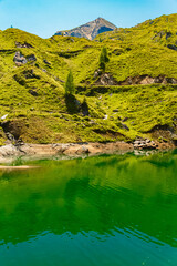 Alpine summer view with reflections in a lake at Mount Kitzsteinhorn, Kaprun, Hohe Tauern mountains, Salzburg, Austria