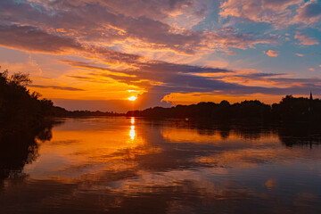 Summer sunset or sundowner view with reflections near Stephansposching, Danube, Deggendorf, Bavaria, Germany