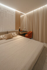 Bedroom with a bed, bedside table and lamps