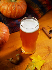 autumn pumpkin beer on a wooden table.