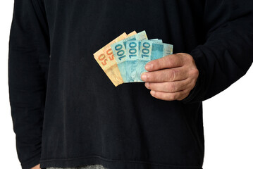 Brazil Financial value of Brazilian real notes. Man holding banknotes. Economy, tourism, business,...