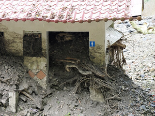 Close-up of Restroom Entrance Filled with Mudslide Debris