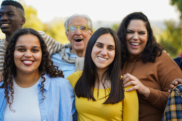 Group of multiracial diverse people smiling in front of camera outdoor - Multi generational...