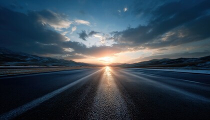 Fototapeta premium Serene Asphalt Highway Road With Snow-Capped Mountains In Natural Landscape Under Sun And Cloudy Sky. Car Driving On Straight Road.