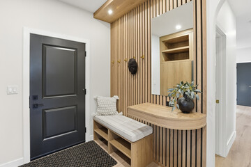 Black door with a wooden frame and a white trim