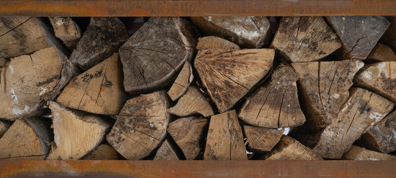 Stack of wooden stumps in cross section texture background with rusty metal frame - Wood woods forest long wide panorama banner pattern.