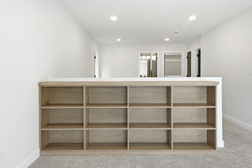Large wooden bookshelf with a white wall behind it