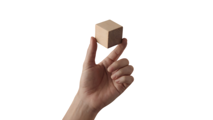 human hand holding simple wooden cube against a backdrop . Isolated on transparent background, png