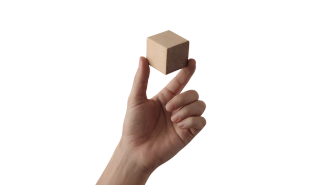 human hand holding simple wooden cube against a backdrop . Isolated on transparent background, png