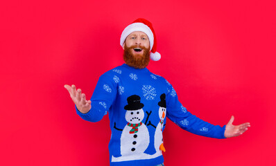 Santa Claus singing Christmas songs studio. Bearded man singing in Santa hat isolated on red