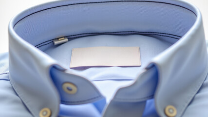 Blue shirt collar folded neatly with top button visible and white inside lining